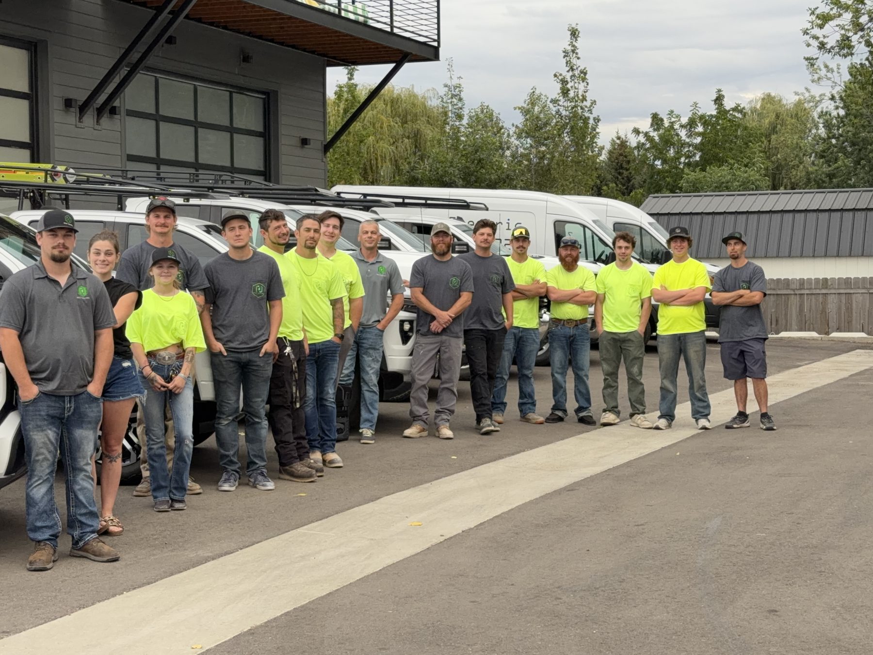 The Keely Electric team standing with their service trucks in Star, Idaho